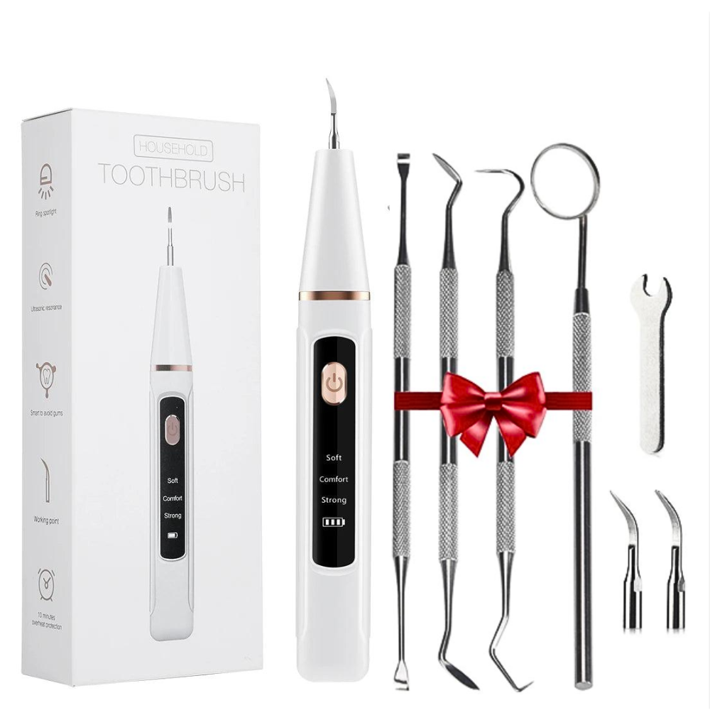 Dental tool set with a white electric toothbrush and various dental instruments on a white background.
